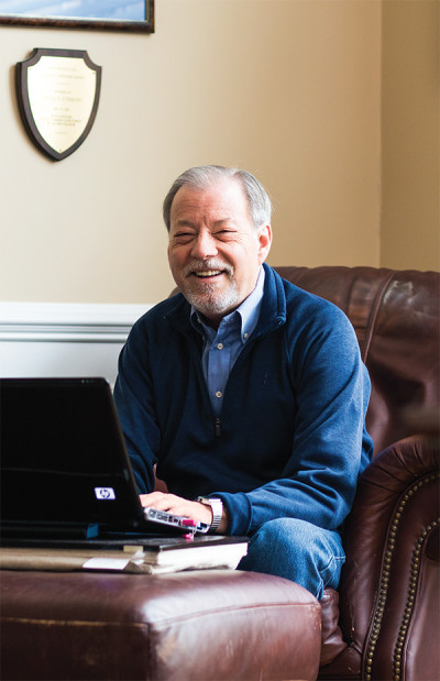 Photo: Pat PiaseckiRomance writer Kevin Symmons, MBA’81, in his home office in Plymouth, Massachusetts