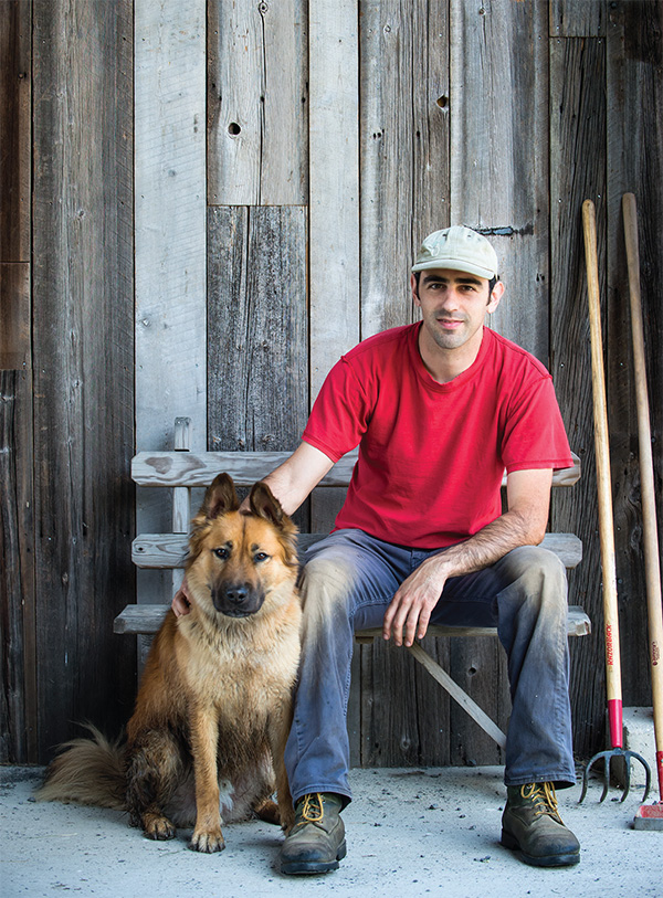 Photo: Jennifer May Jesse Tolz works the farm—where he sells vegetables, herbs, flowers, and seeds—with his adopted dog, Oso.