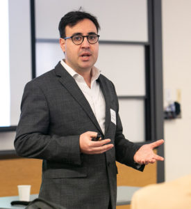 Rubén Mancha, assistant professor of information systems, discusses his research with colleagues.