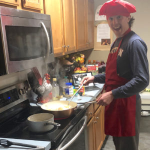 Ryan Wilson ’23 cooking in kitchen.