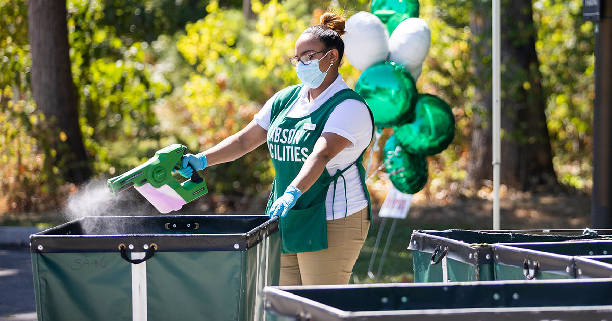 Facilities worker sanitizing move-in carts