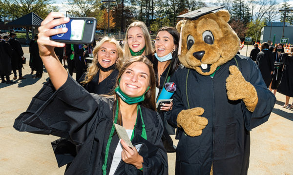 Graduates pose for a selfie with Biz E. Beaver