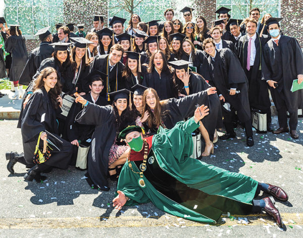 President Spinelli poses with a group of graduates