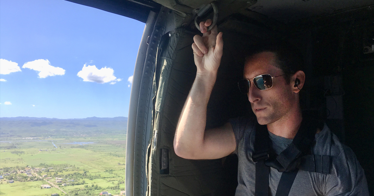 Jesse Levin looks out of a helicopter