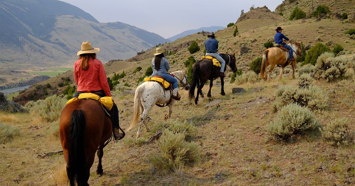 People riding horses at West Creek Ranch