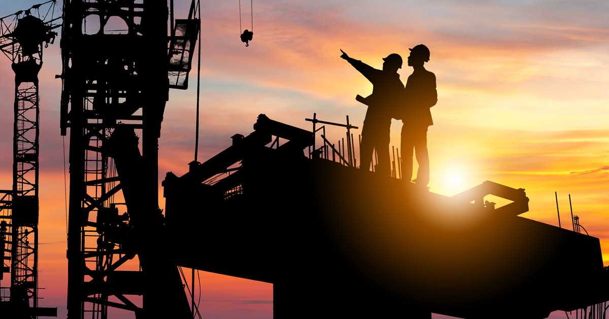 two men pointing at a construction site