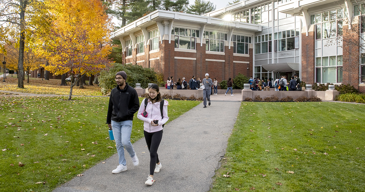 Students walk on the Babson campus outside of Olin Hall