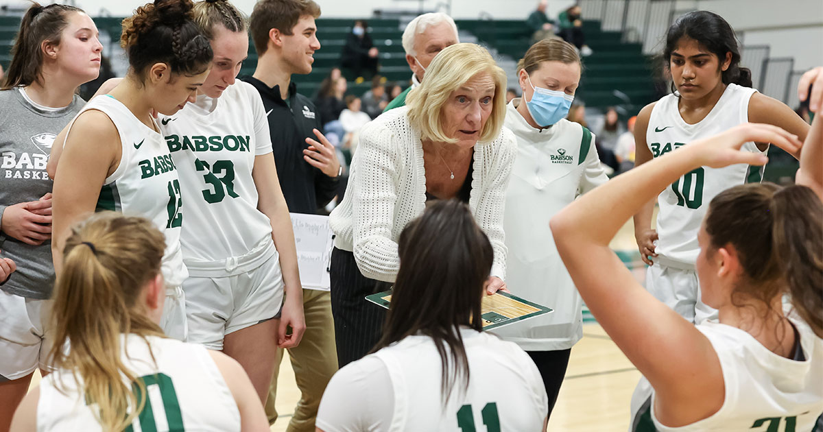 Judy Blinstrub talks with her players at a basketball game