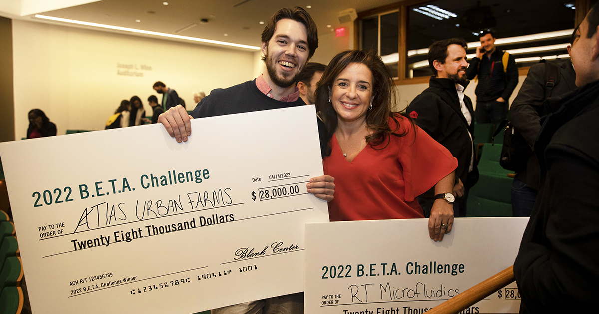Connor Harbison and Nathalya Mamane hold up their grand-prize checks