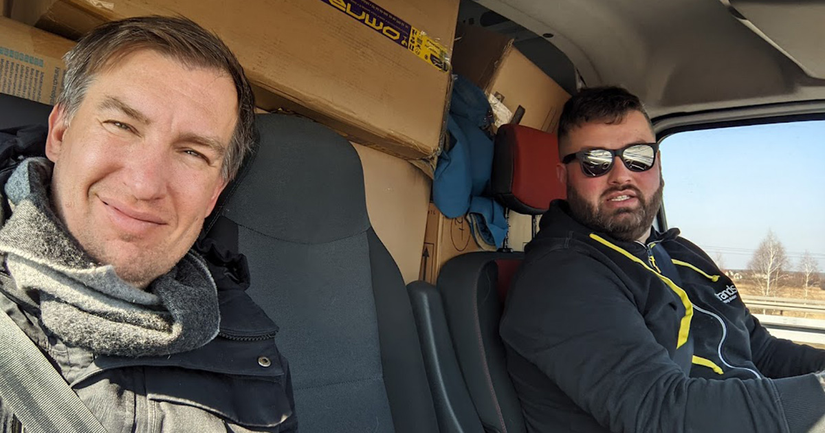 Adam Sulkowski and Christopher Jaworski pose for a photo in Jaworski's van