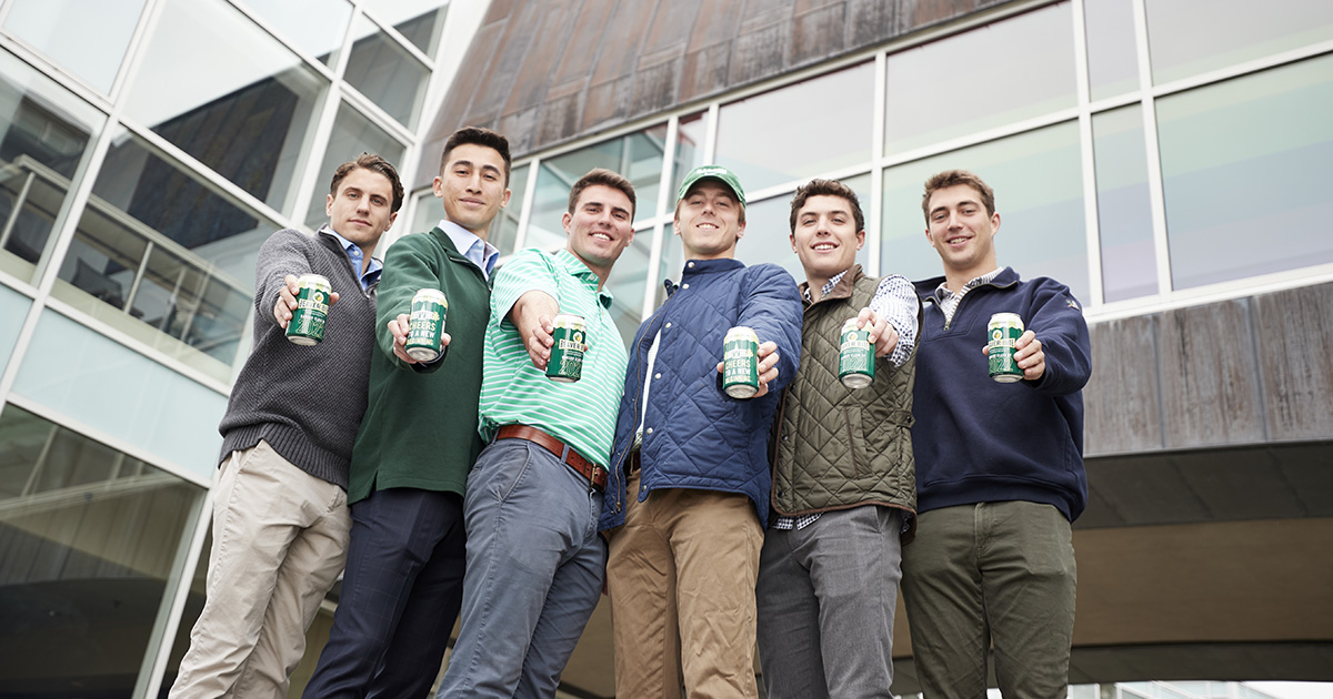 The students who made Beaver Bite holding a can of the drink.