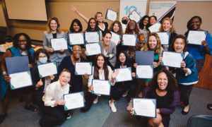 Participants pose for a group photo with their certificates
