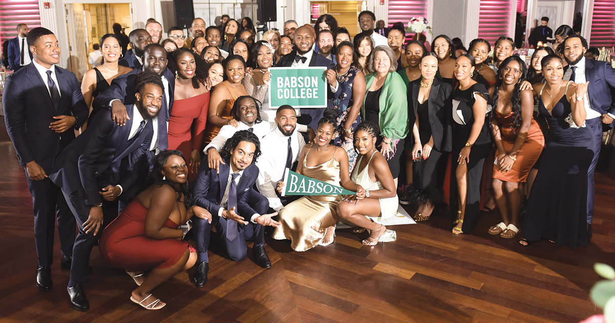 Shatiek Gatlin and Shakiyah Copening pose for a wedding photo with family and friends