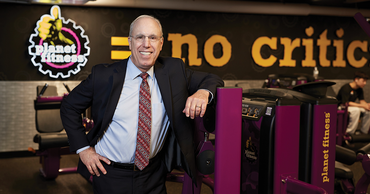 Stephen Spinelli poses for a portrait in a Planet Fitness gym
