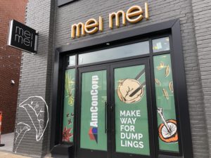 Image of a storefront building with Mei Mei Dumplings signage.