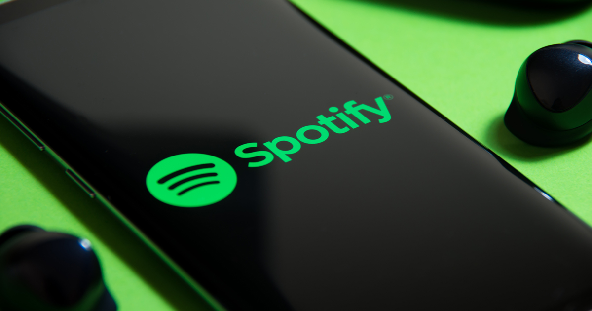 A cell phone showing the logo of Spotify
