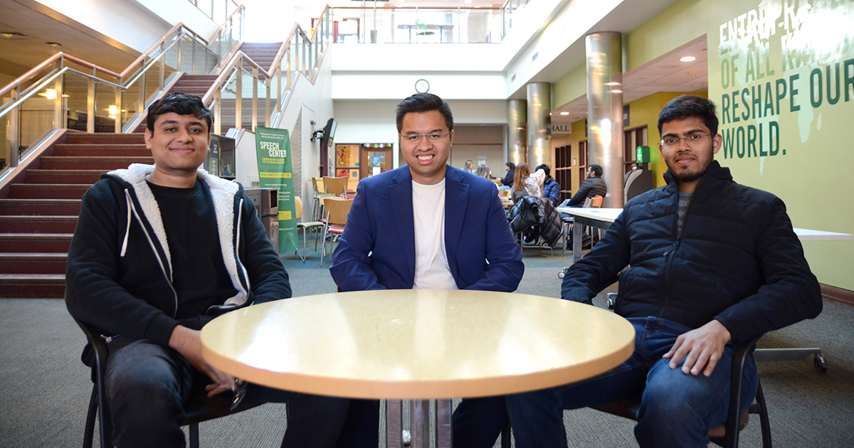 Three Babson graduate students at a table