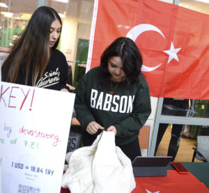 Students gather donations with Turkish flag in the background.