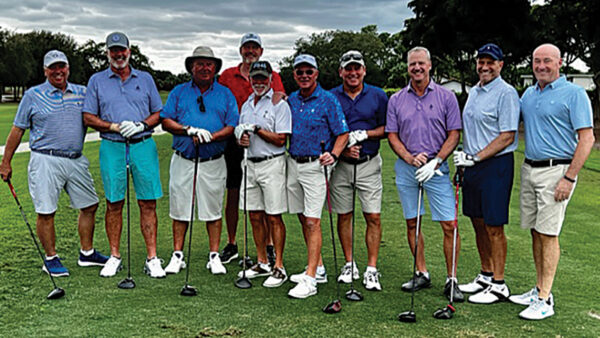 Alumni pose for a photo at their annual golf reunion
