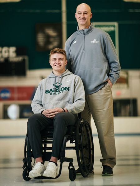 Jake Thibeault and Jamie Rice pose for a photo on the ice in the Babson Skating Center