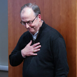 Richard Goulding puts his hand on his chest after receiving his award