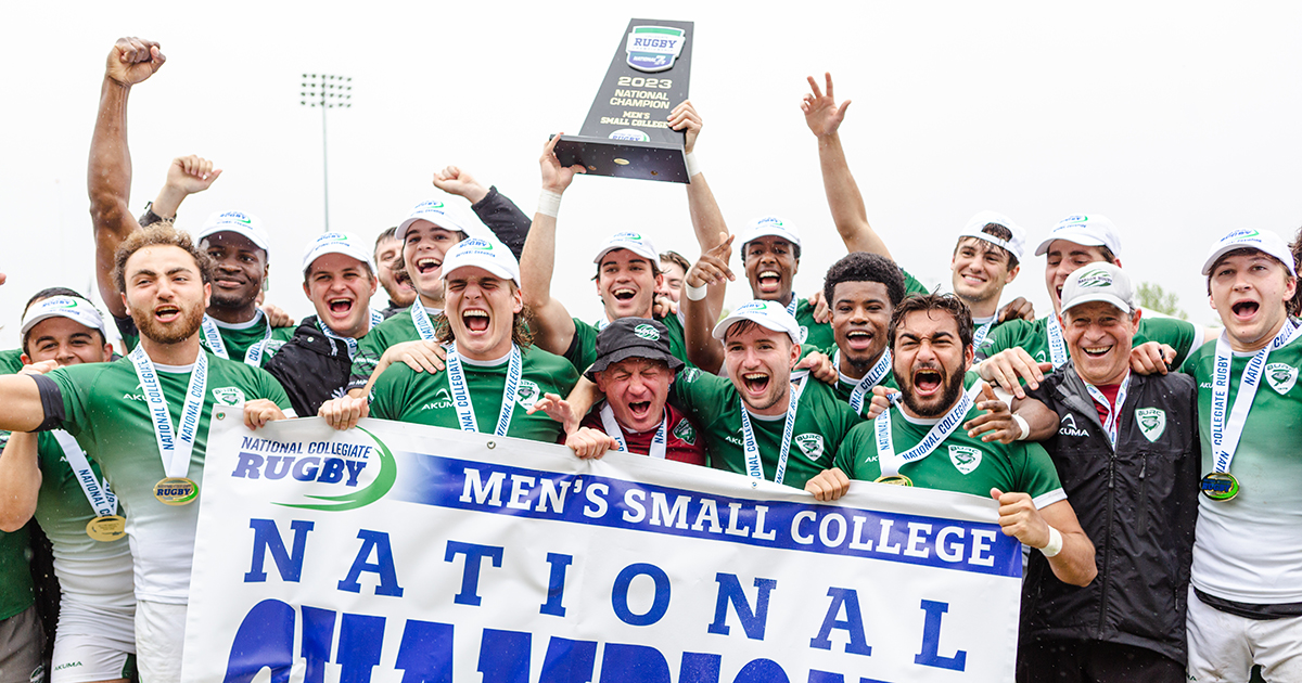 The Babson team poses for a photo while celebrating and lifting the trophy