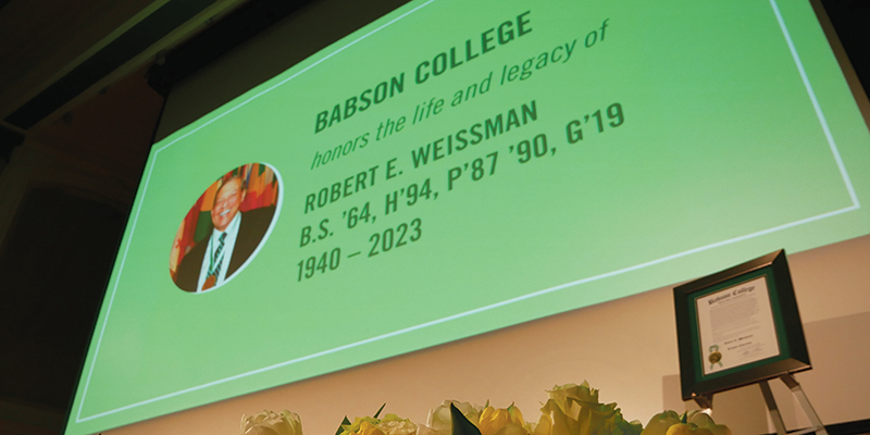 Closeup of the screen honoring Bob Weissman at the event