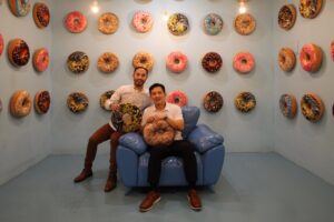 HOLEO Golf & Museum co-founders Andre Husada MSEL’20 and Rexanders Gautama MSEL’20 sit in the donut room.