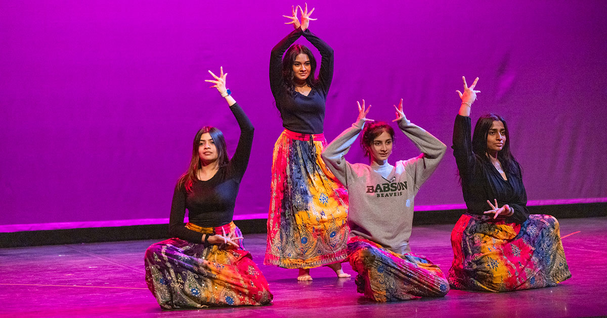 four dancers strike a pose on stage