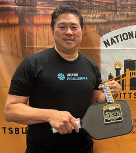 Bernie Lee poses for a photo with his prize