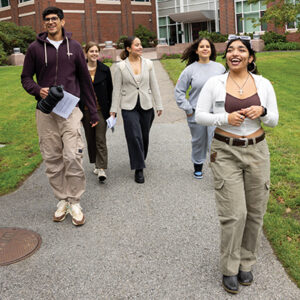 A group of students walk on a tour of campus