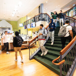 Students walk down stairs into Trim Dining Hall
