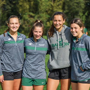 Four women's soccer players pose for a photo