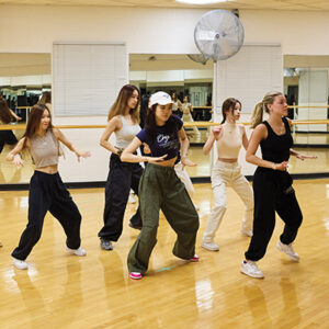 A small group of dancers practice in the studio