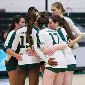 Volleyball players huddle during a match