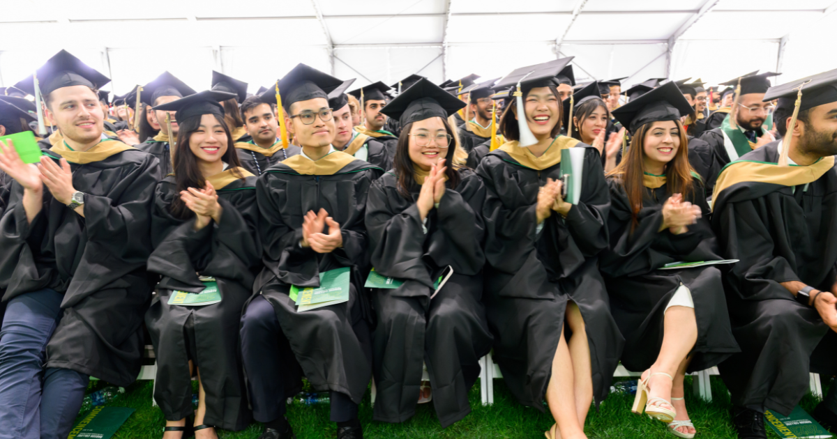 A group of Babson graduates sitting during Commencement 2023.