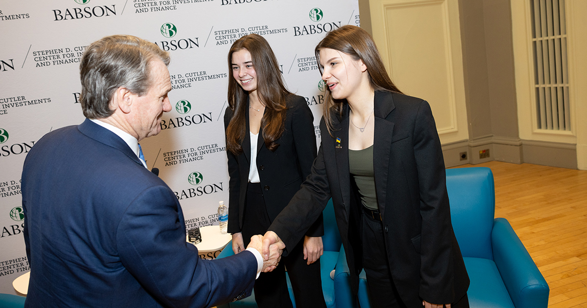 Oleksandra Mukha ’26 and Emily Truszkowski ’26 greet Bank of America CEO Brian Moynihan