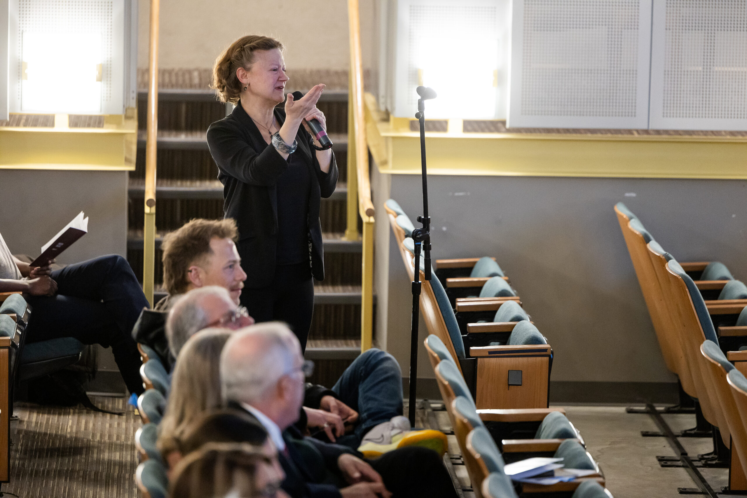 An audience member asks a question at an opera recital performance.