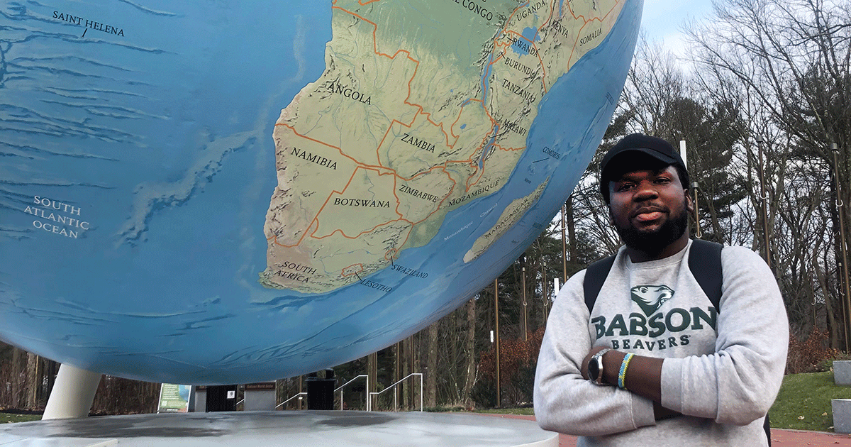 Emmanuel Nsanganwa stands by the Babson World Globe