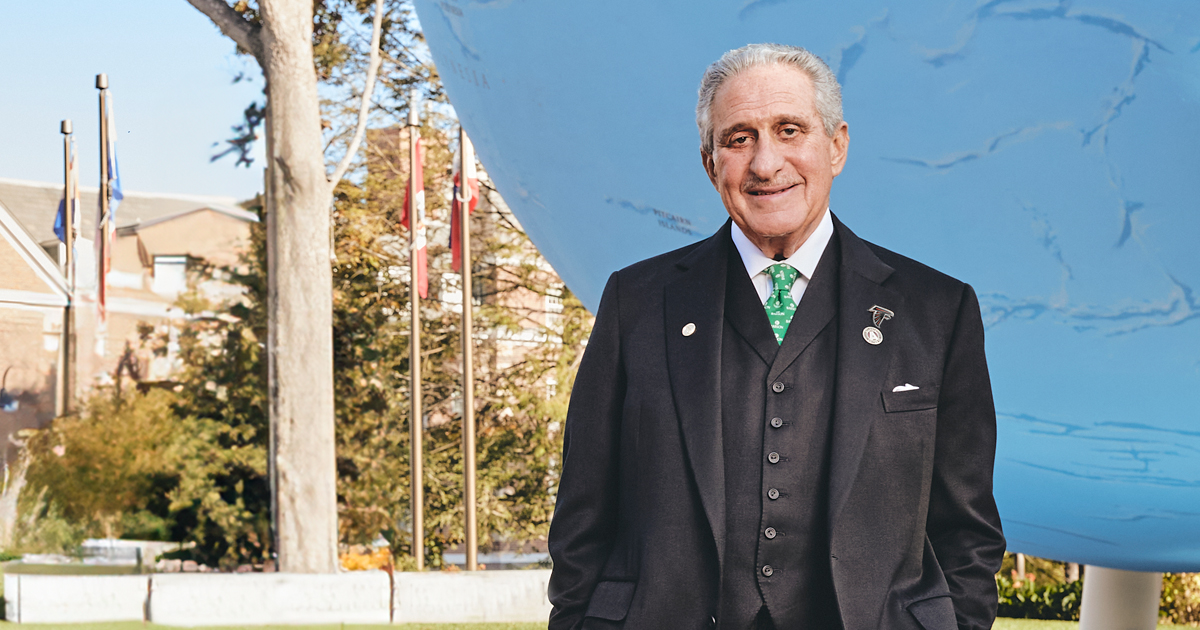 Arthur Blank poses for a photo in front of the Babson Globe