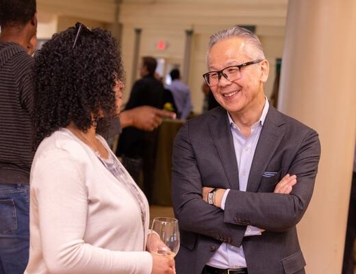 Matsuno, pictured chatting at his farewell celebration in Knight's Auditorium, will return to the faculty as marketing professor after his sabbatical. (Photo: Nic Czarnecki)