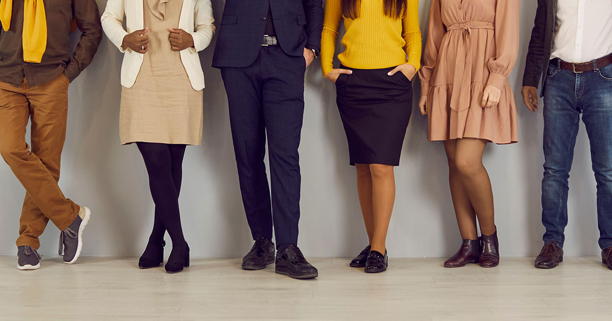 six people stand in a line wearing different work outfits