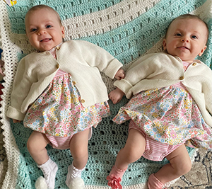 Twin daughters smile for a photo