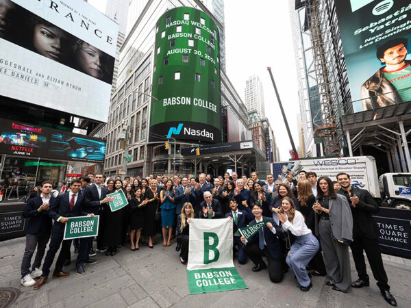 Karen Snow ’93 is joined by Babson President Stephen Spinelli Jr. MBA’92, PhD and Babson Professor Joel Shulman P’12 ’14 ’20 at the Nasdaq MarketSite. (Photo courtesy Nasdaq)