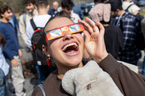 A student dons special glasses to view the solar eclipse