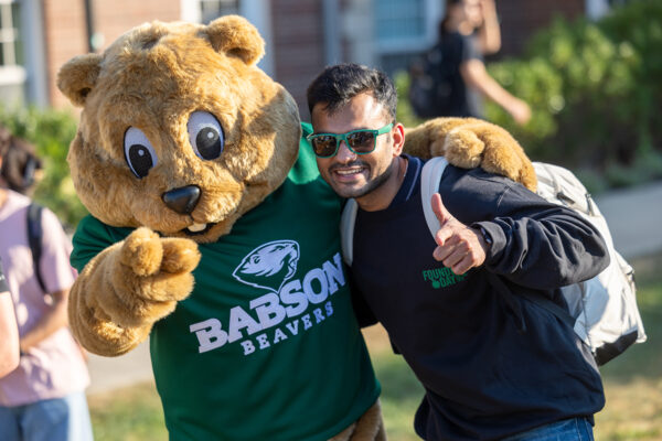 Biz E. Beaver and a student give the thumbs-up on Founder's Day