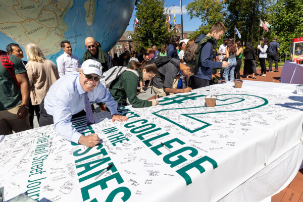 President Spinelli signs a banner proclaiming Babson No. 2