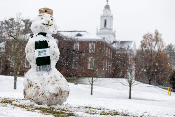 A snowman wears a Babson scarf on campus after the first snowfall of the year