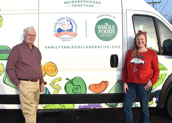 Henry (left) and Wheeler (right) outside a refrigerated van donated by Whole Foods Market earlier this year.