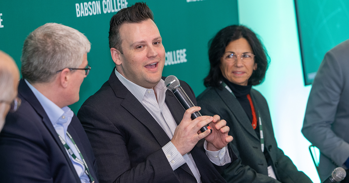 Three people talking on a panel